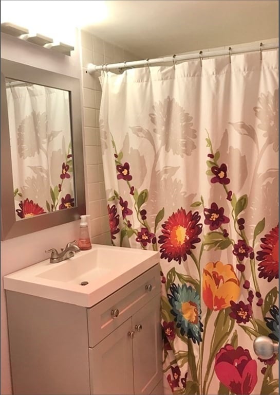 bathroom featuring a shower with curtain and vanity