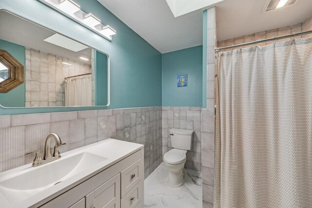 51 Wianno Cir, Barnstable, MA 02655 - full bath featuring toilet, vanity, tile walls, marble finish flooring, and curtained shower