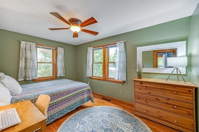51 Wianno Cir, Barnstable, MA 02655 - bedroom featuring multiple windows, wood finished floors, and a ceiling fan