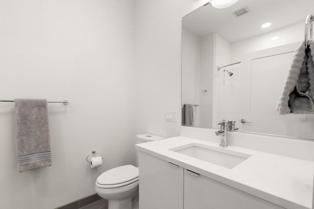full bath with vanity, toilet, visible vents, and a shower