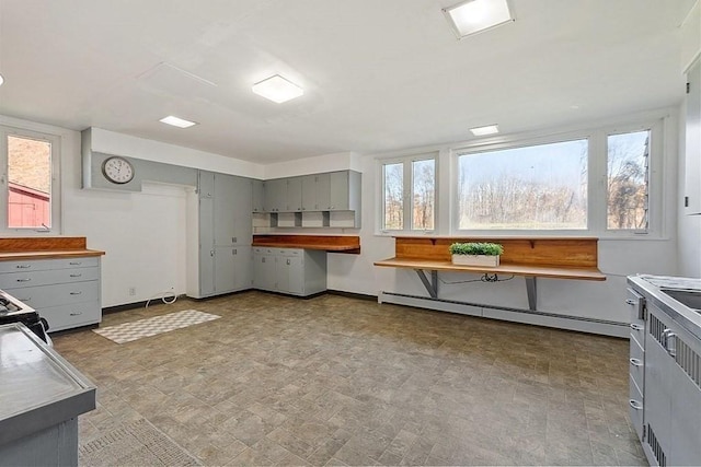 kitchen featuring a baseboard heating unit and gray cabinetry