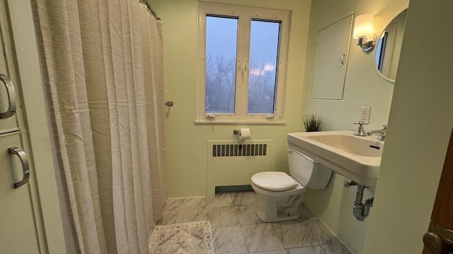 bathroom with toilet, walk in shower, and radiator