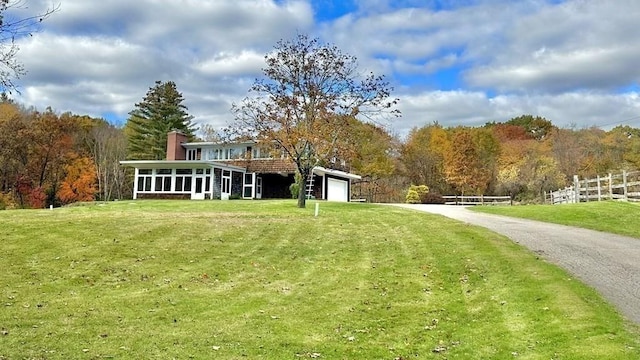 view of yard with a sunroom and a garage