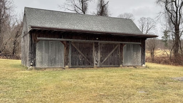 view of outbuilding featuring a yard