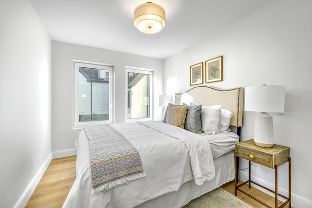 bedroom featuring baseboards and light wood-style floors