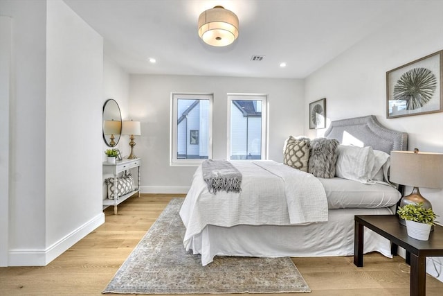 bedroom featuring light wood-type flooring, baseboards, visible vents, and recessed lighting