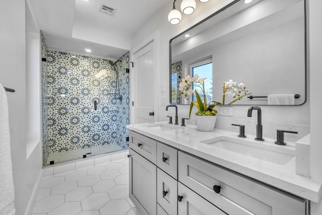 full bathroom with a shower stall, visible vents, and a sink