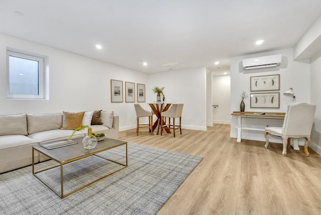 living room with light wood-style floors, recessed lighting, baseboards, and a wall mounted AC