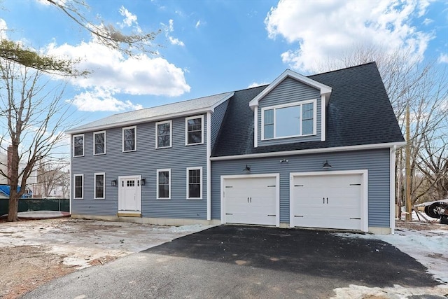 colonial home with a shingled roof and driveway