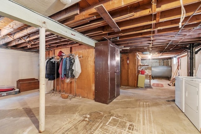 unfinished basement featuring heating fuel and separate washer and dryer