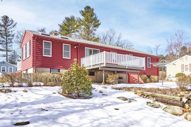 view of front of property with a chimney and a wooden deck