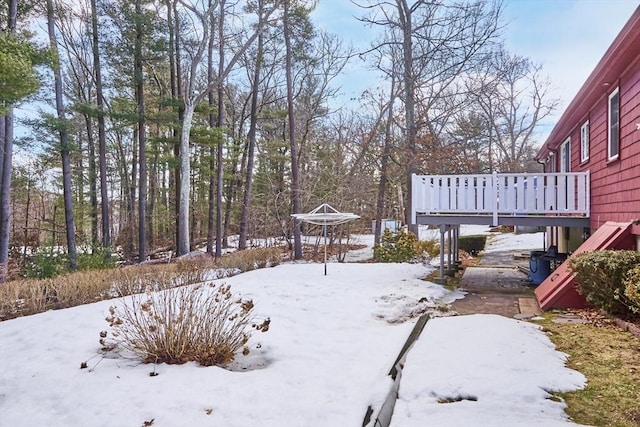 yard layered in snow featuring a wooden deck