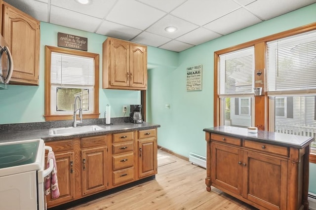 16 Boyce St, Worcester, MA 01603 - kitchen with dark countertops, baseboard heating, plenty of natural light, light wood finished floors, and a drop ceiling