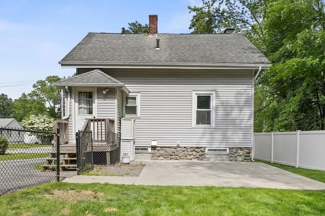 16 Boyce St, Worcester, MA 01603 - rear view of house with a patio, a chimney, and roof with shingles