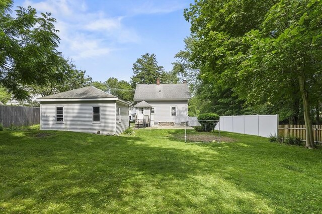 16 Boyce St, Worcester, MA 01603 - rear view of property featuring a fenced backyard and an outbuilding