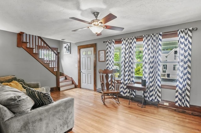 16 Boyce St, Worcester, MA 01603 - living room with wood finished floors, stairway, ceiling fan, and a textured ceiling