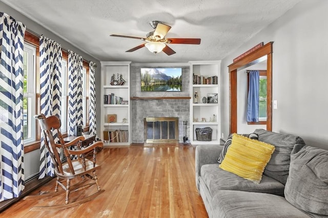 16 Boyce St, Worcester, MA 01603 - living area with plenty of natural light, a ceiling fan, hardwood / wood-style flooring, built in shelves, and a textured ceiling
