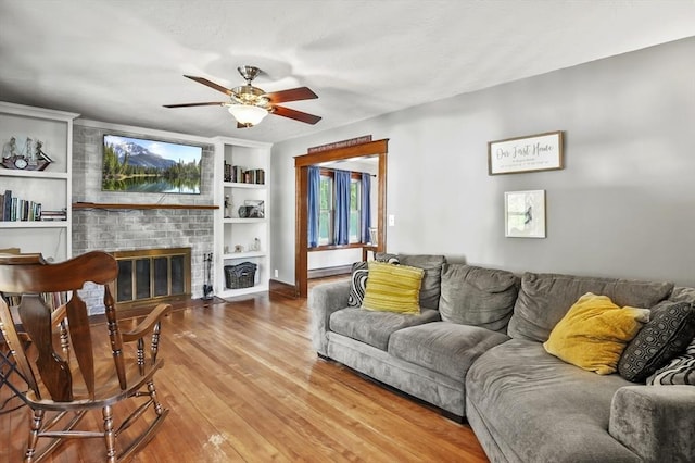 16 Boyce St, Worcester, MA 01603 - living room with ceiling fan, wood finished floors, a fireplace, and built in shelves