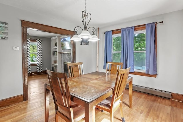 16 Boyce St, Worcester, MA 01603 - dining room featuring a baseboard heating unit, light wood finished floors, and a chandelier