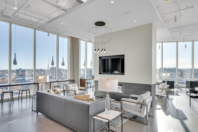 living room with concrete flooring, floor to ceiling windows, and plenty of natural light