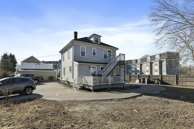378-380 Neponset Ave, Boston, MA 02122 - back of property featuring stairway, a wooden deck, concrete driveway, and a chimney