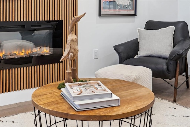 living area featuring a warm lit fireplace