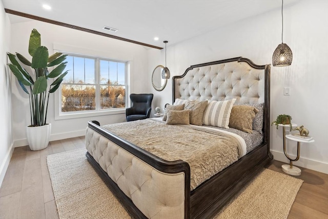 bedroom with visible vents, recessed lighting, wood finished floors, and baseboards