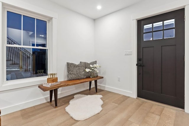 entryway featuring stairway, recessed lighting, baseboards, and wood finished floors