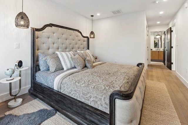 bedroom with visible vents, recessed lighting, baseboards, and wood finished floors