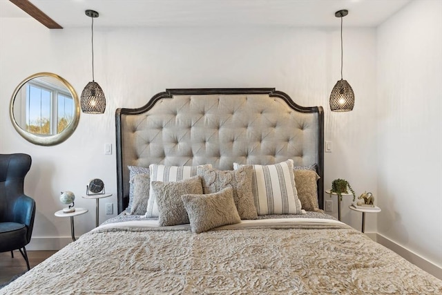 bedroom with baseboards and wood finished floors