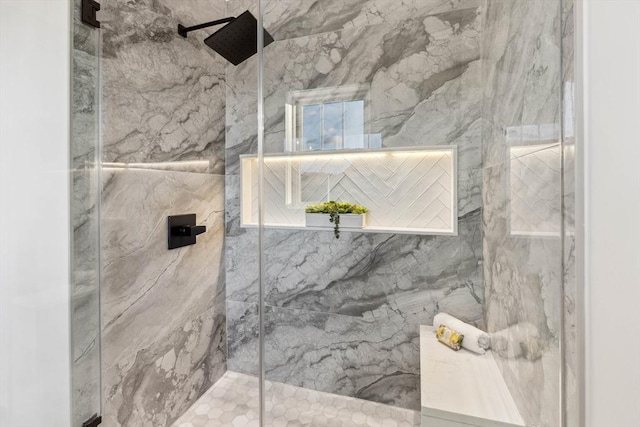 bathroom with a marble finish shower