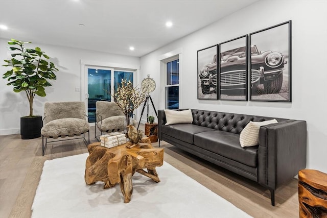 living area featuring recessed lighting, wood finished floors, and baseboards