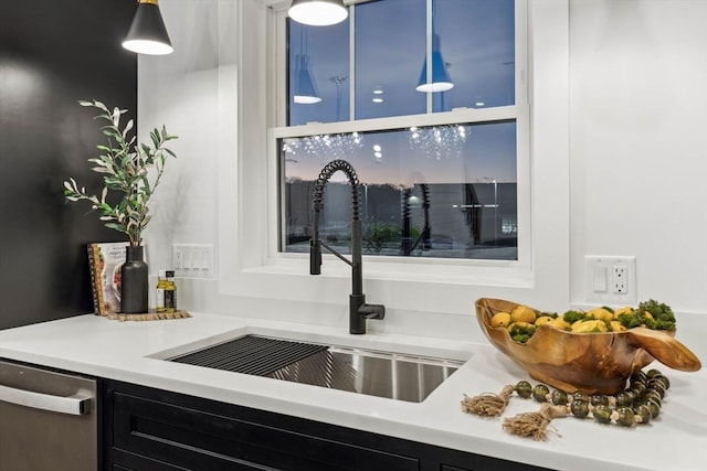 interior space with dishwasher, dark cabinets, and a sink