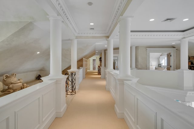 hall featuring ornamental molding, light colored carpet, and ornate columns