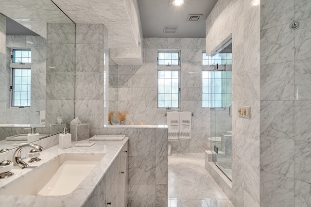 bathroom featuring tile walls, vanity, and an enclosed shower