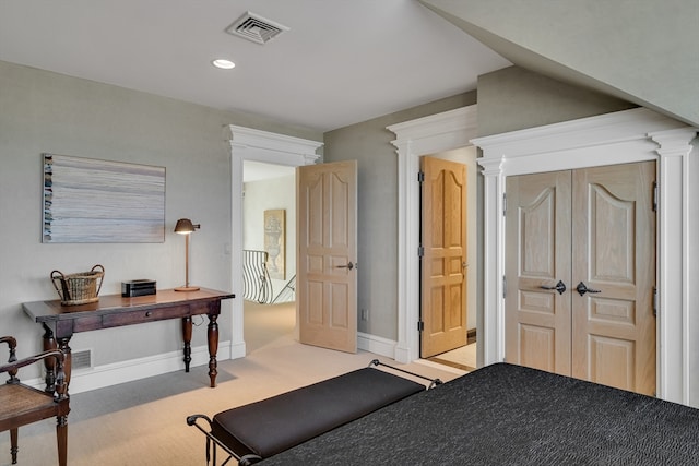 carpeted bedroom featuring decorative columns