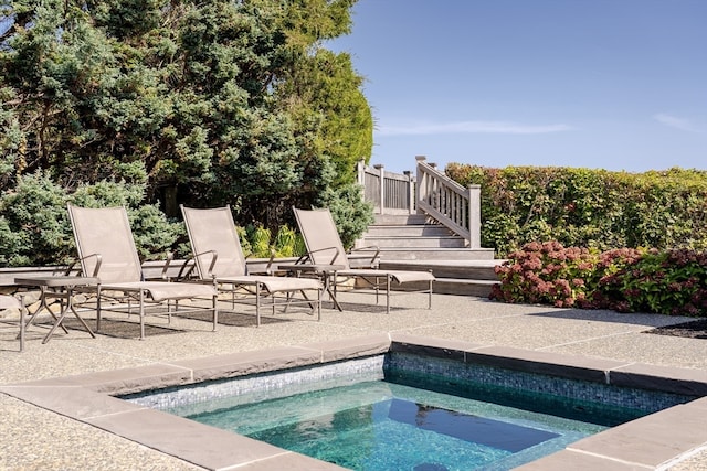 view of pool with an in ground hot tub