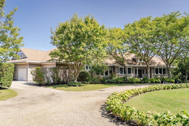 view of front of home with a garage and a front lawn