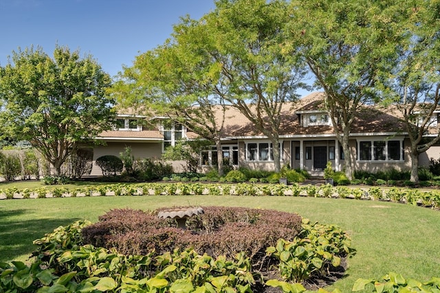 rear view of property with a lawn