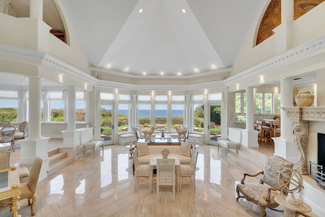 interior space with french doors, decorative columns, and a fireplace