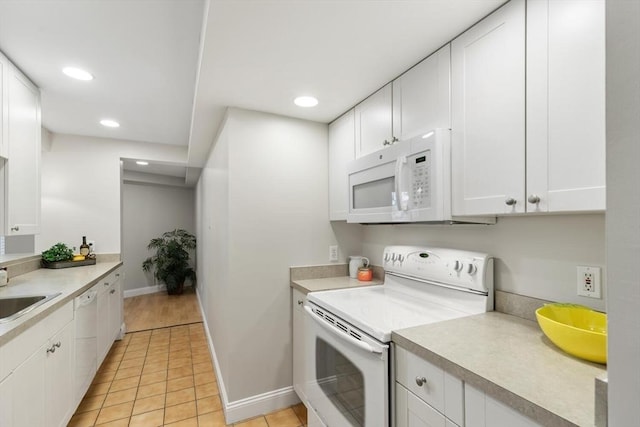 1 Loring Ave Unit 206, Swampscott, MA 01907 - kitchen featuring white appliances, white cabinetry, light countertops, baseboards, and recessed lighting