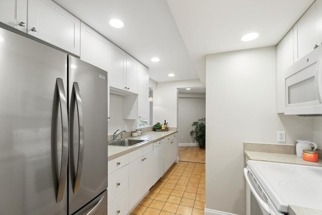 1 Loring Ave Unit 206, Swampscott, MA 01907 - kitchen with white appliances, a sink, light countertops, white cabinetry, and light tile patterned floors