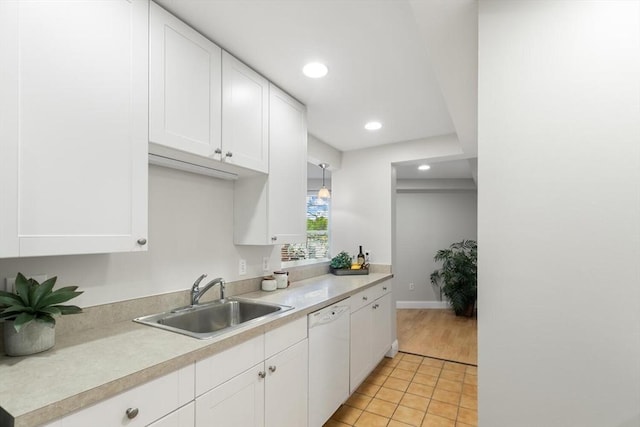 1 Loring Ave Unit 206, Swampscott, MA 01907 - kitchen with a sink, dishwasher, white cabinetry, light countertops, and light tile patterned floors