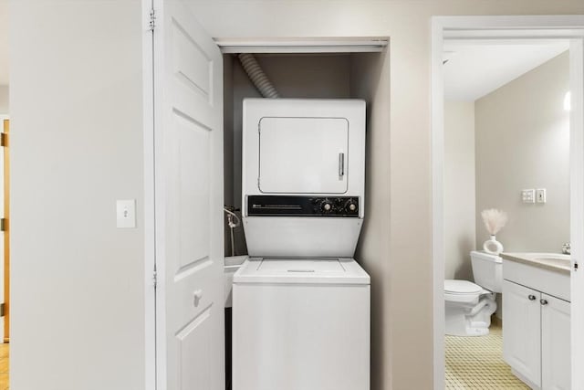 1 Loring Ave Unit 206, Swampscott, MA 01907 - laundry room featuring stacked washer and clothes dryer