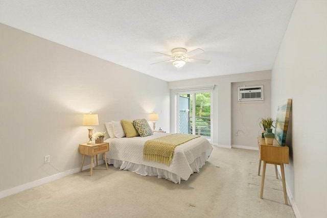 1 Loring Ave Unit 206, Swampscott, MA 01907 - bedroom with a wall mounted air conditioner, light colored carpet, baseboards, and access to outside