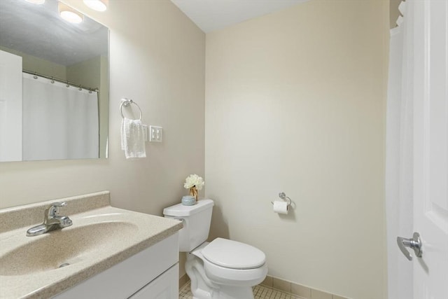 1 Loring Ave Unit 206, Swampscott, MA 01907 - full bath featuring vanity, toilet, tile patterned flooring, and baseboards