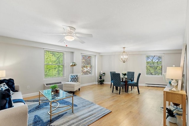 1 Loring Ave Unit 206, Swampscott, MA 01907 - living room featuring a baseboard heating unit, plenty of natural light, a chandelier, and light wood-style flooring