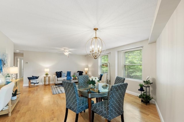 1 Loring Ave Unit 206, Swampscott, MA 01907 - dining room with light wood-style flooring, a chandelier, baseboards, and a ceiling fan