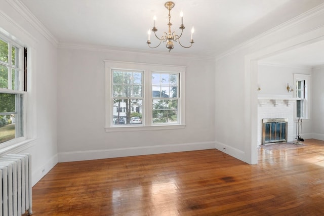 interior space with a healthy amount of sunlight, radiator, and hardwood / wood-style floors