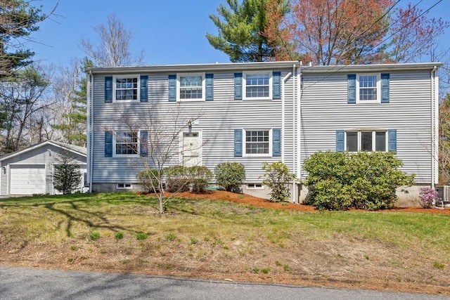 view of front of property with an outdoor structure, a garage, a front yard, and central AC unit